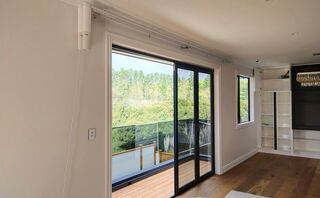 Double motorised curtain tracks with rechargeable battery powered motors for a new home